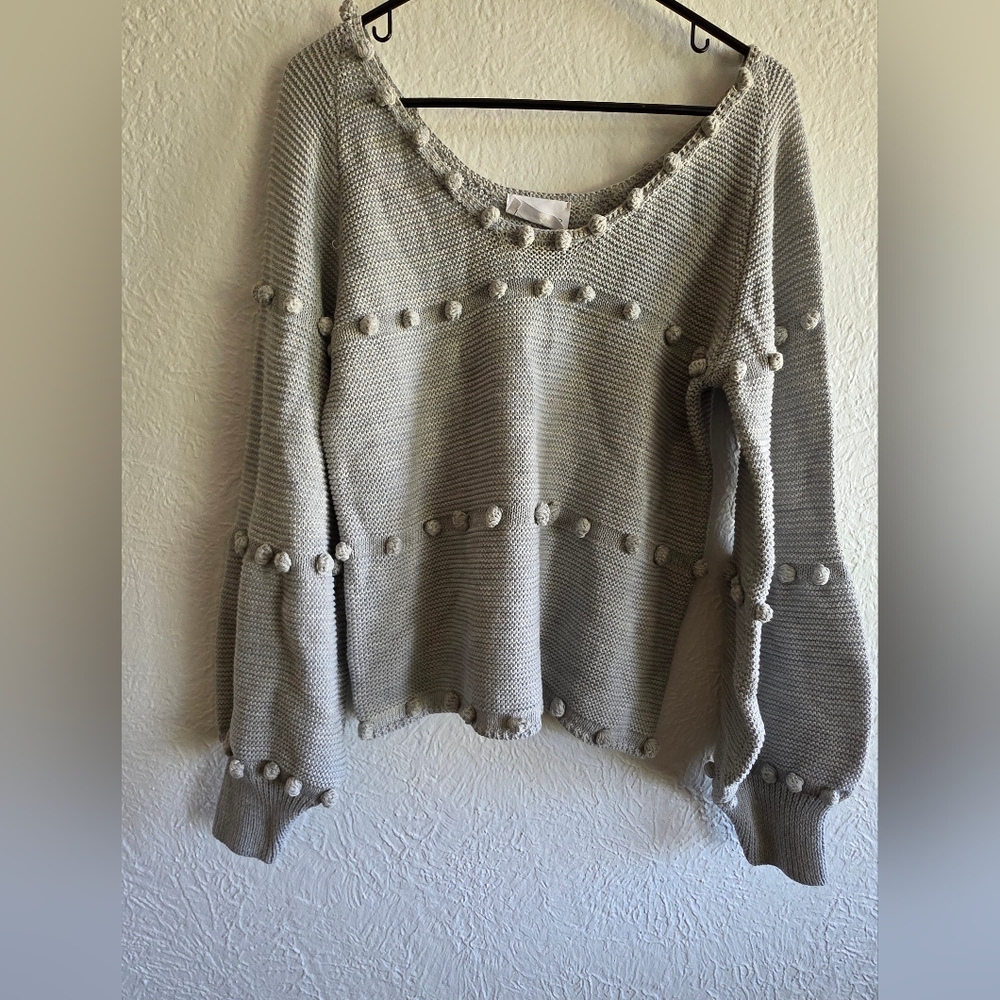Elegant V-Neck Sweater with Pom-Pom Accents